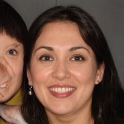 Joyful white adult female with long  brown hair and brown eyes