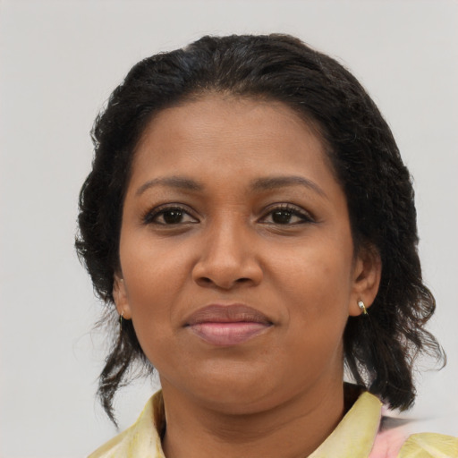 Joyful black young-adult female with medium  brown hair and brown eyes