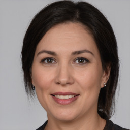 Joyful white adult female with medium  brown hair and brown eyes