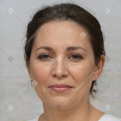 Joyful white adult female with medium  brown hair and brown eyes