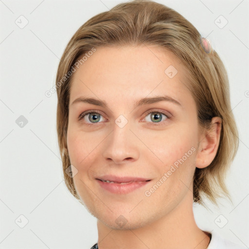 Joyful white young-adult female with medium  brown hair and grey eyes