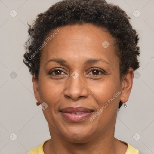 Joyful black adult female with short  brown hair and brown eyes