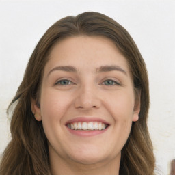 Joyful white young-adult female with long  brown hair and green eyes