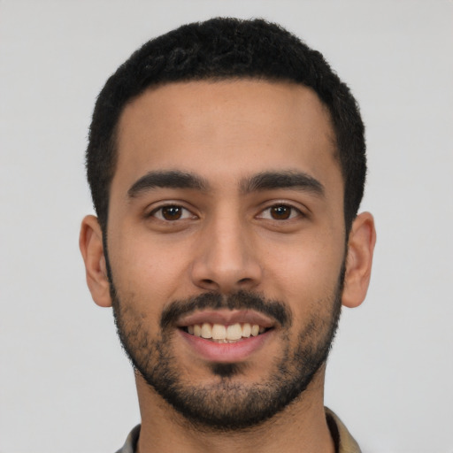 Joyful latino young-adult male with short  black hair and brown eyes