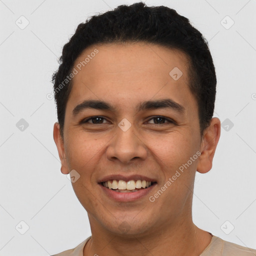 Joyful latino young-adult male with short  black hair and brown eyes