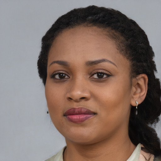 Joyful black young-adult female with medium  black hair and brown eyes