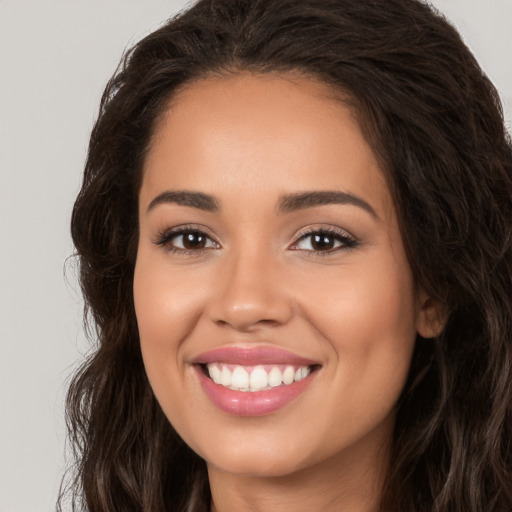 Joyful white young-adult female with long  brown hair and brown eyes