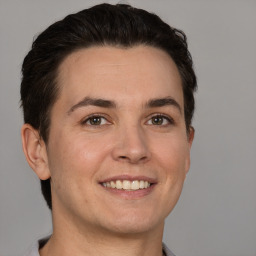 Joyful white young-adult male with short  brown hair and brown eyes