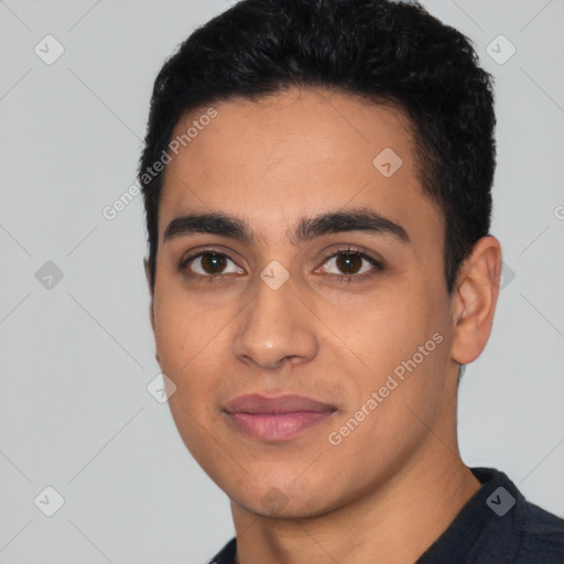 Joyful latino young-adult male with short  black hair and brown eyes