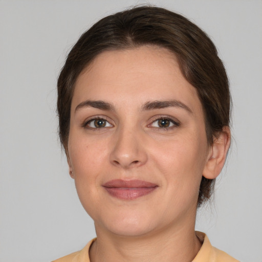 Joyful white young-adult female with medium  brown hair and brown eyes