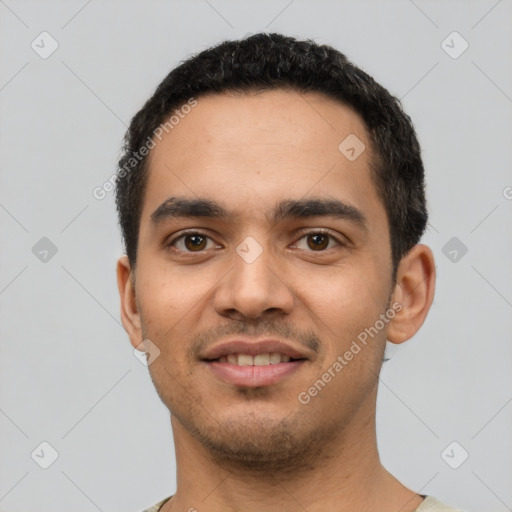 Joyful latino young-adult male with short  black hair and brown eyes