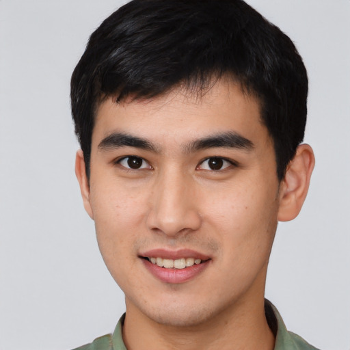 Joyful asian young-adult male with short  black hair and brown eyes