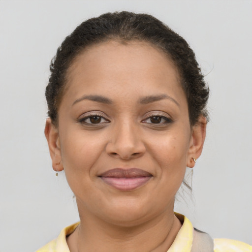 Joyful latino young-adult female with short  brown hair and brown eyes