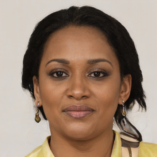 Joyful black adult female with medium  brown hair and brown eyes