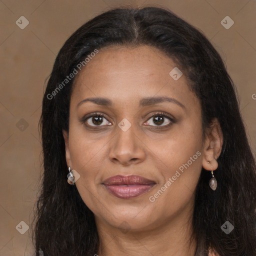 Joyful black young-adult female with long  brown hair and brown eyes