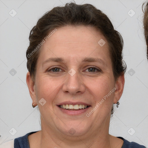 Joyful white adult female with short  brown hair and grey eyes