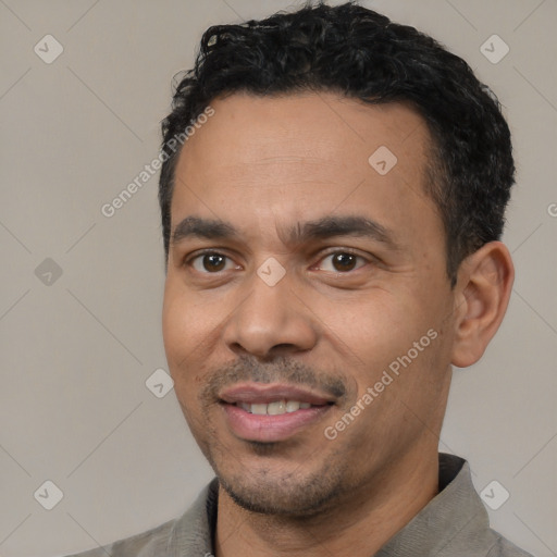 Joyful latino adult male with short  black hair and brown eyes