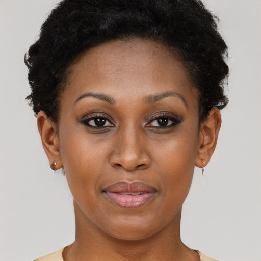 Joyful black young-adult female with short  brown hair and brown eyes