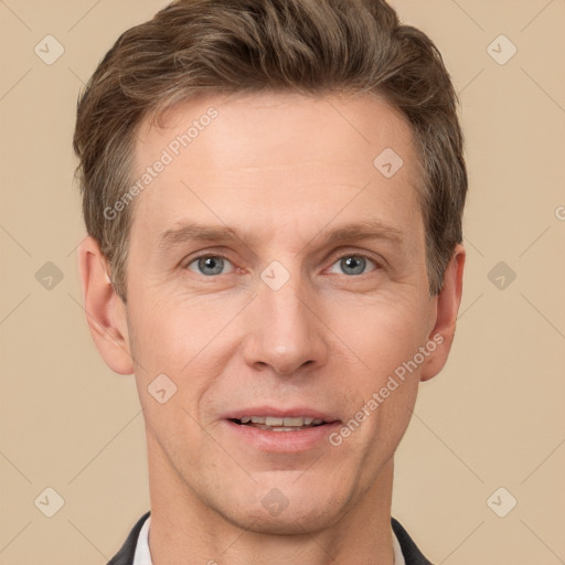 Joyful white adult male with short  brown hair and grey eyes