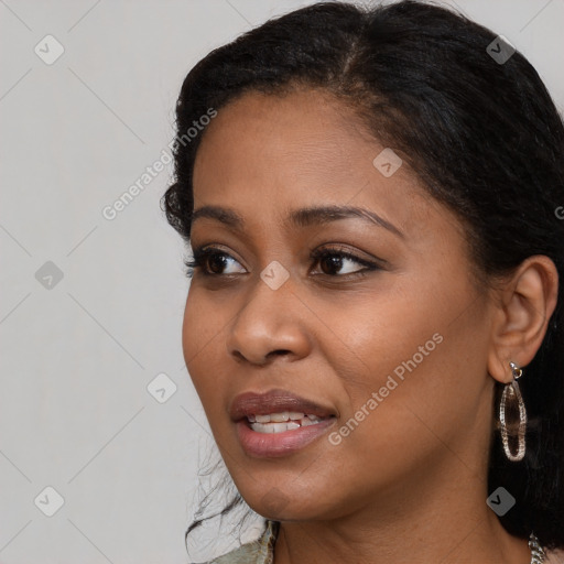 Joyful black young-adult female with long  brown hair and brown eyes