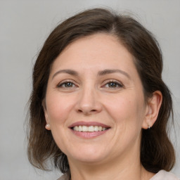 Joyful white adult female with medium  brown hair and brown eyes