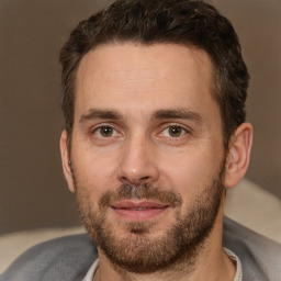 Joyful white adult male with short  brown hair and brown eyes