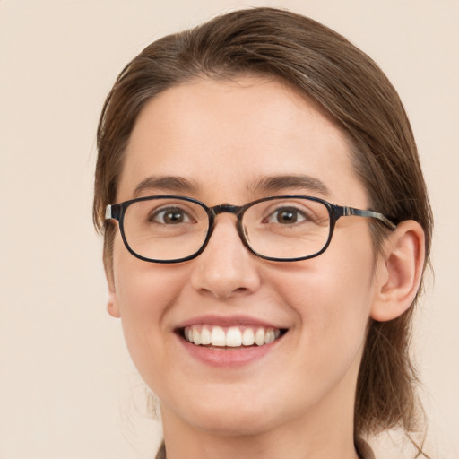 Joyful white young-adult female with medium  brown hair and blue eyes