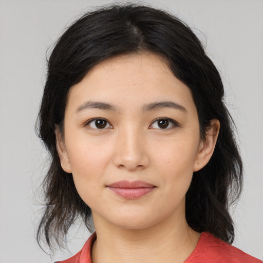 Joyful white young-adult female with medium  black hair and brown eyes