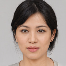 Joyful asian young-adult female with medium  black hair and brown eyes