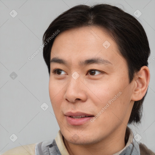 Joyful asian young-adult male with short  brown hair and brown eyes