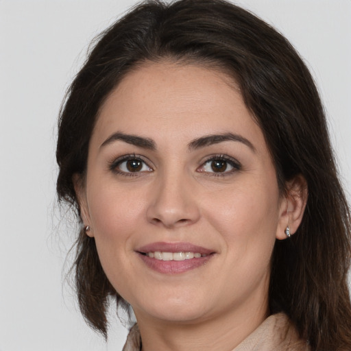 Joyful white young-adult female with medium  brown hair and brown eyes