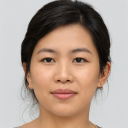 Joyful asian young-adult female with medium  brown hair and brown eyes