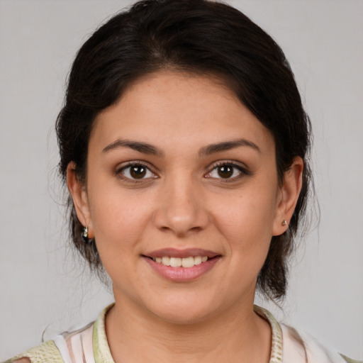 Joyful white young-adult female with medium  brown hair and brown eyes