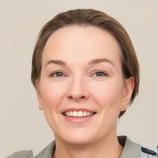 Joyful white adult female with short  brown hair and grey eyes