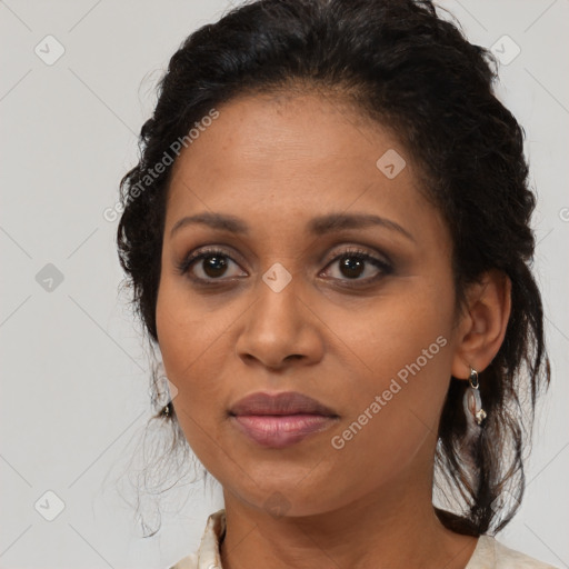 Joyful latino adult female with medium  brown hair and brown eyes