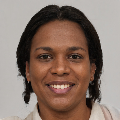 Joyful black young-adult female with medium  brown hair and brown eyes