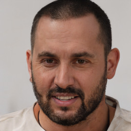 Joyful white adult male with short  brown hair and brown eyes