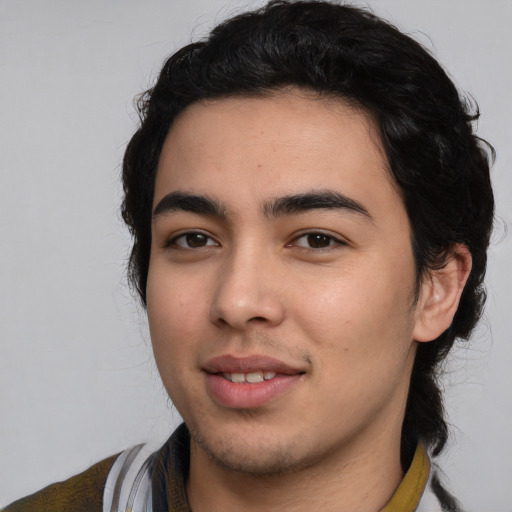 Joyful white young-adult male with medium  black hair and brown eyes