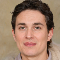 Joyful white adult male with short  brown hair and brown eyes