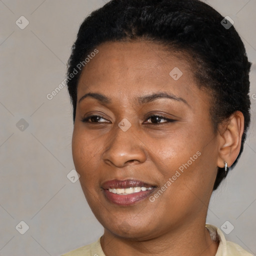 Joyful black young-adult female with short  black hair and brown eyes