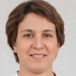 Joyful white adult female with short  brown hair and brown eyes