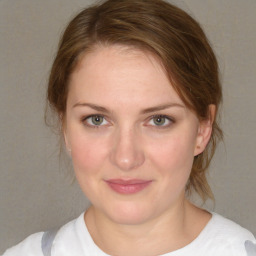 Joyful white young-adult female with medium  brown hair and blue eyes