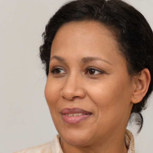 Joyful latino adult female with medium  brown hair and brown eyes