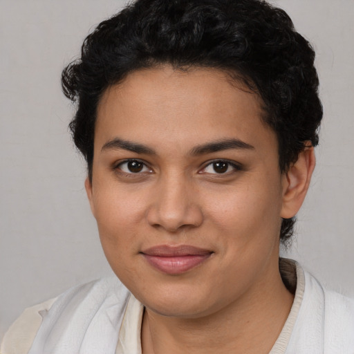 Joyful latino young-adult female with short  black hair and brown eyes