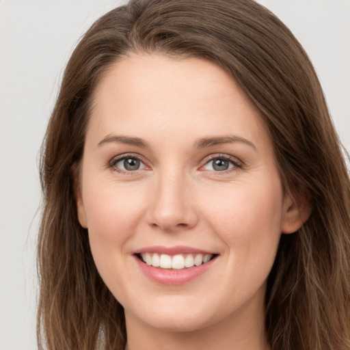 Joyful white young-adult female with long  brown hair and grey eyes