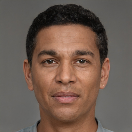 Joyful white adult male with short  black hair and brown eyes