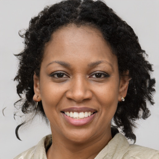 Joyful black young-adult female with medium  brown hair and brown eyes