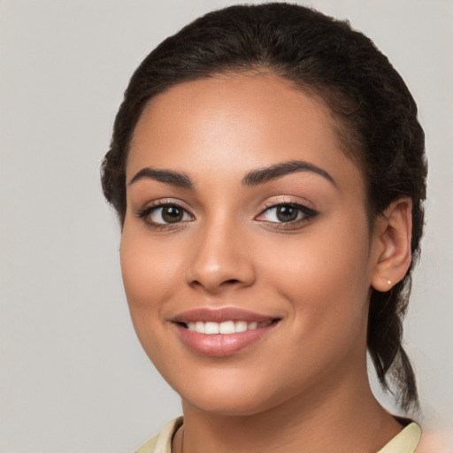 Joyful white young-adult female with long  brown hair and brown eyes