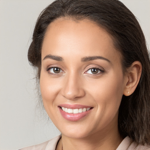 Joyful white young-adult female with long  brown hair and brown eyes