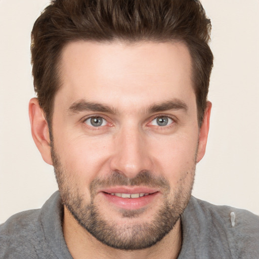 Joyful white young-adult male with short  brown hair and brown eyes